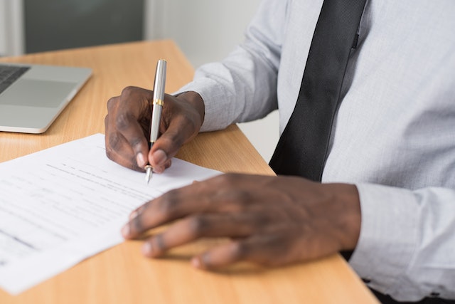 someone signing a paper